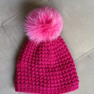 Hot pink Kyi-kyi beanie with large fluffy pompom.